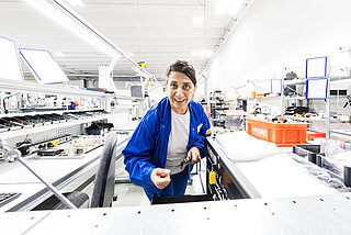 A woman with a tool in her hand at work in INVENOX battery system assembly.